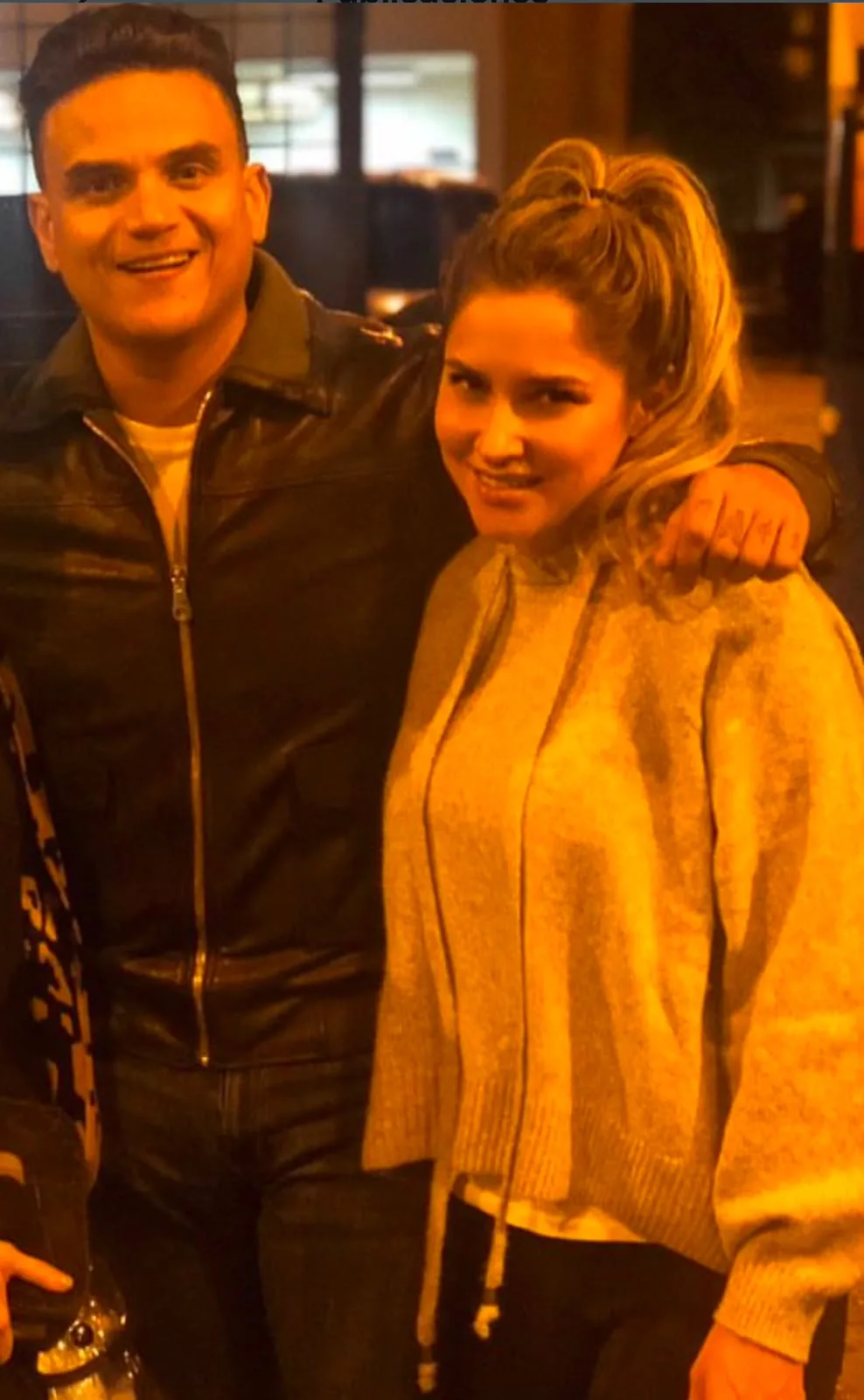 Moni Aristi with an artist in a leather jacket