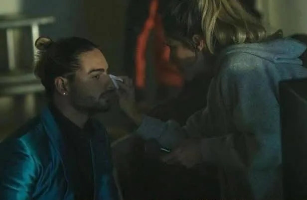Makeup touch-up on a dimly lit shooting set