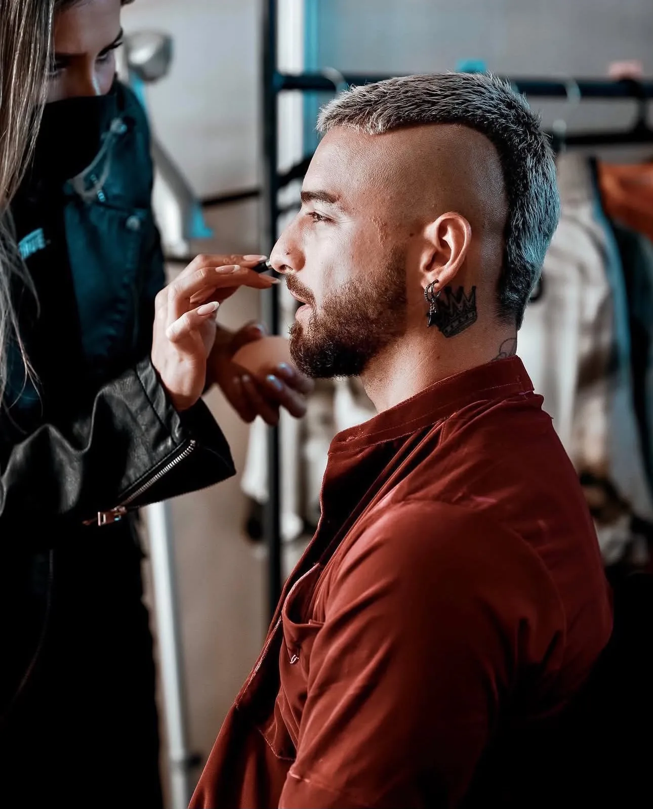 Applying lipstick to an artist in profile backstage