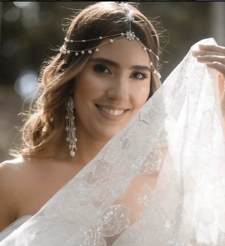 Bride smiling under her veil, natural backlit portrait