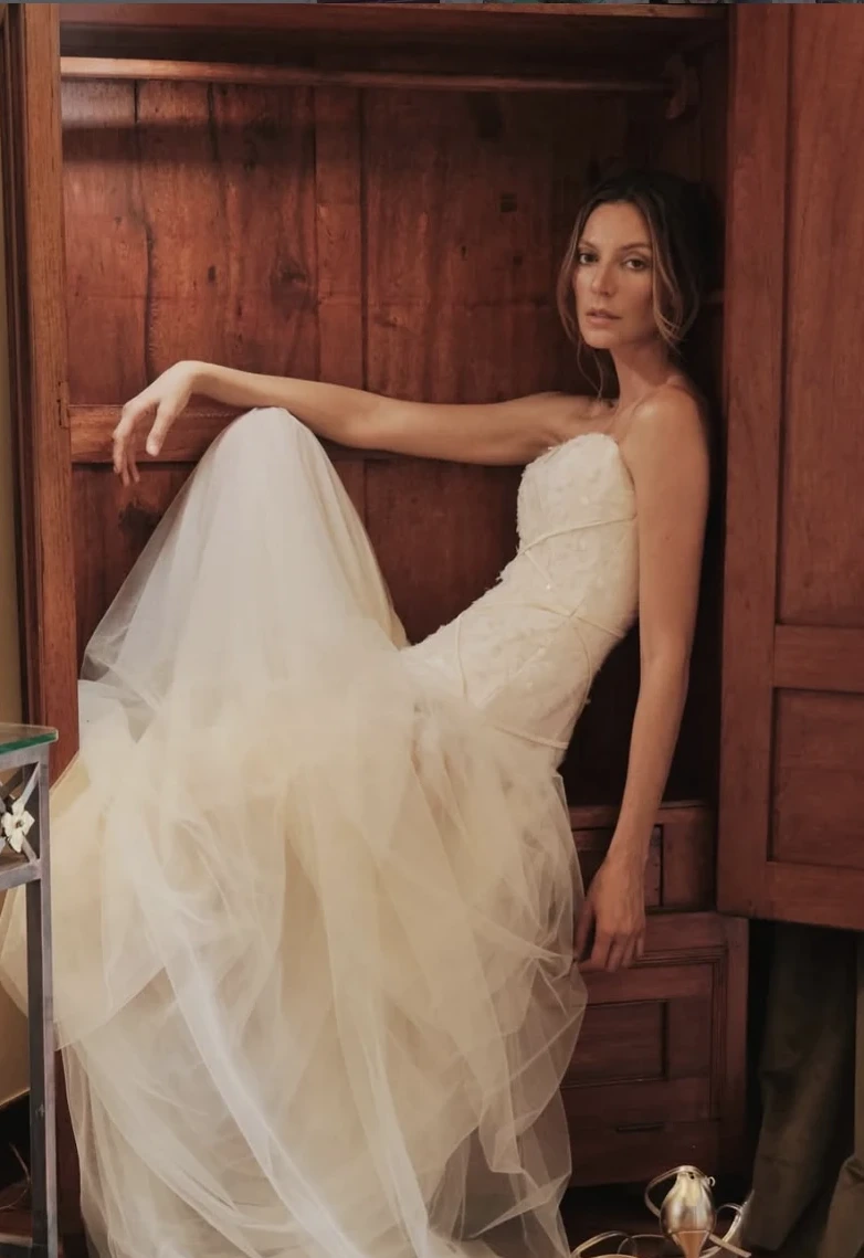 Model in a lace wedding gown inside a wooden wardrobe