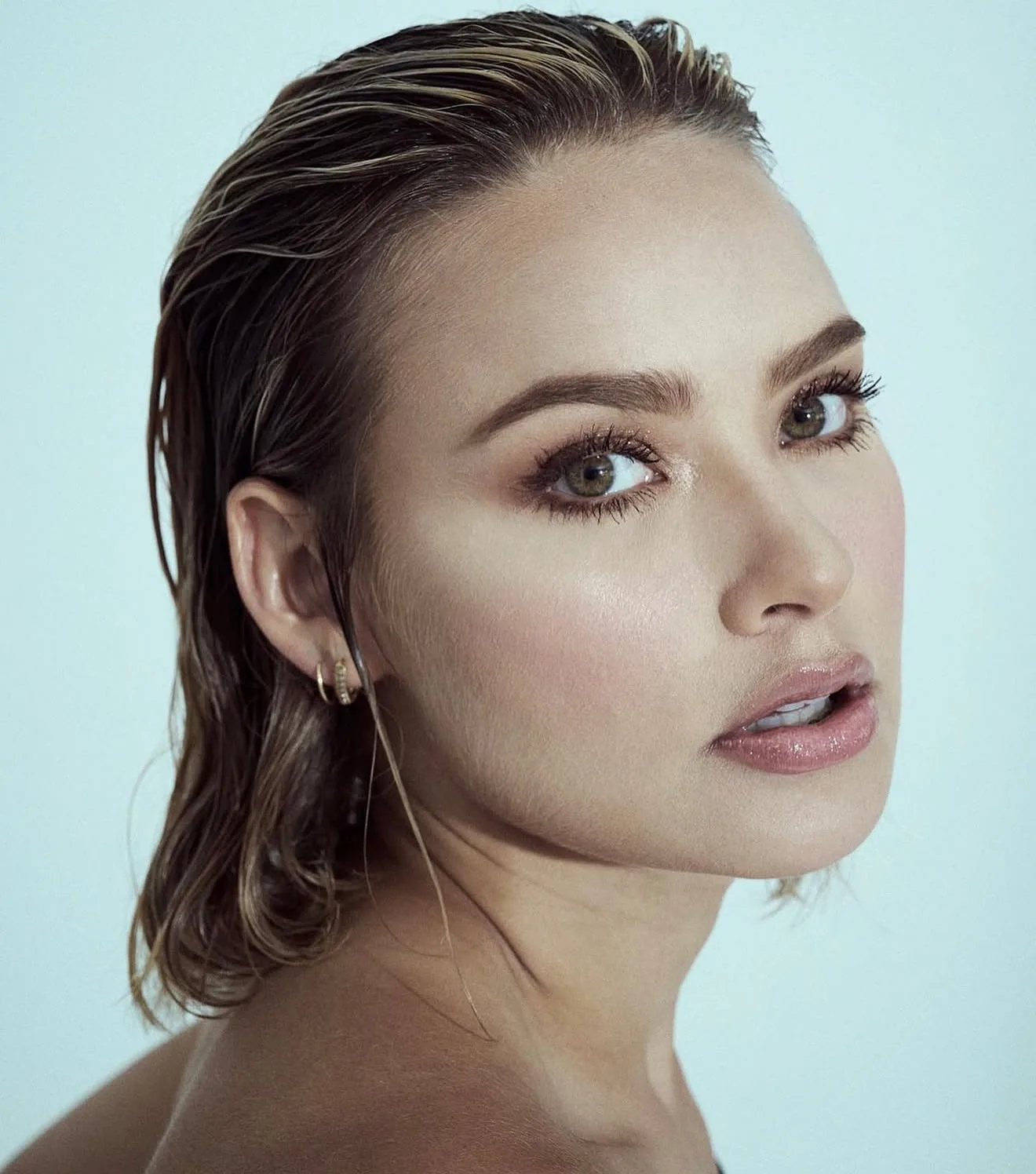 Beauty portrait with luminous skin and wet hair slicked back