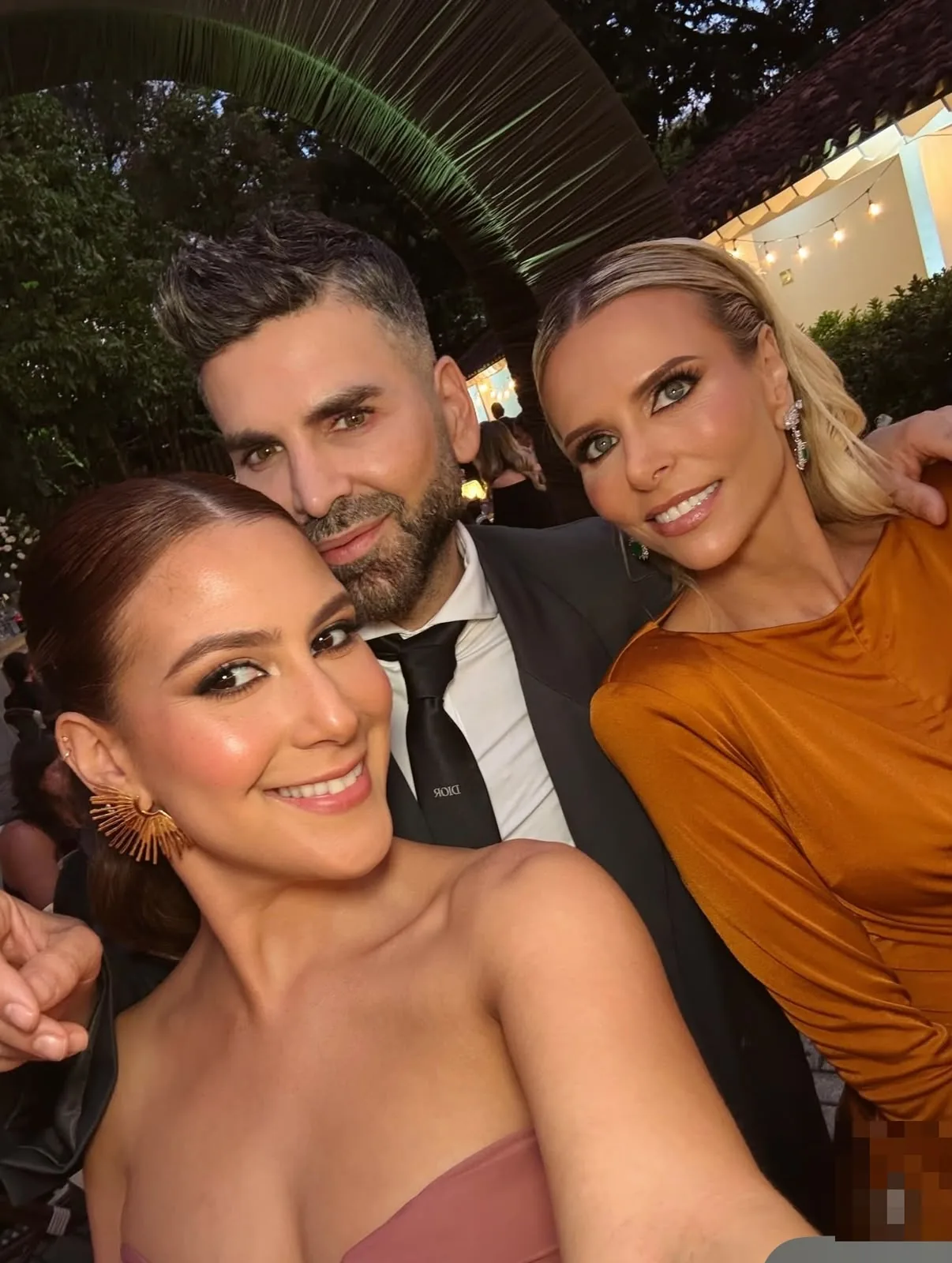 Guests wearing evening glam makeup at an outdoor social event